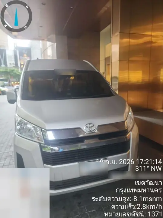 A silver Toyota Commuter at a hotel entrance in Thonglor for drop-off
